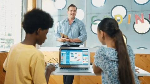 Smart teacher hold tablet while back view student learning code. Edification. Foto stock