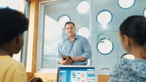 Smart teacher hold tablet while back view student learning code. Edification. Foto stock