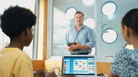 Smart teacher hold tablet while back view student learning code. Edification. Foto stock