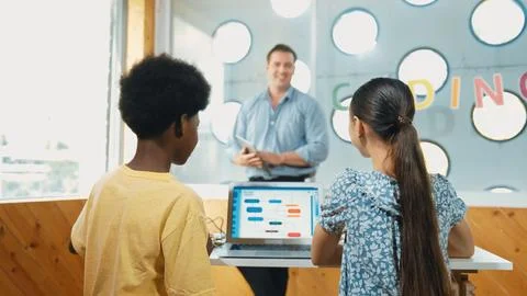 Smart teacher hold tablet while back view student learning code. Edification. Foto stock