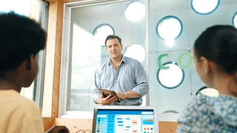 Smart teacher hold tablet while back view student learning code. Edification. Foto stock