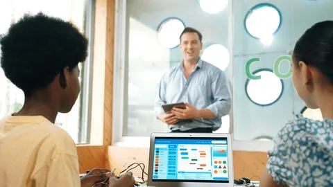 Smart teacher hold tablet while back view student learning code. Edification. Foto stock