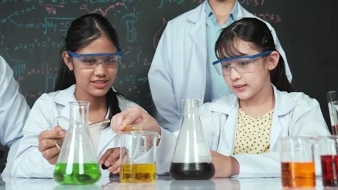 Smart teacher support diverse children doing experiment together. Edification Stock-Footage 276437618