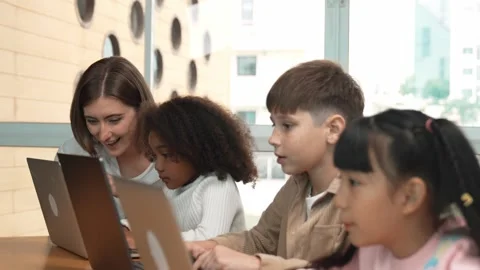 Smart teacher teaching and looking student using laptop at classroom. Erudition. Stock Footage 266326159