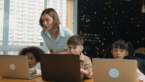 Smart teacher teaching and looking student using laptop at classroom. Erudition. Stock Footage 267921291