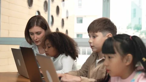 Smart teacher teaching and looking student using laptop at classroom. Erudition. Stock Footage 271730586