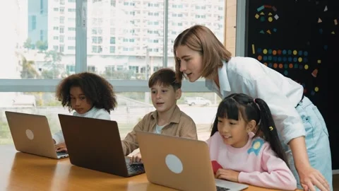 Smart teacher teaching and looking student using laptop at classroom. Erudition. Stock Footage 272667621
