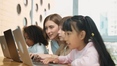 Smart teacher teaching and looking student using laptop at classroom. Erudition. Stock Footage 274527197