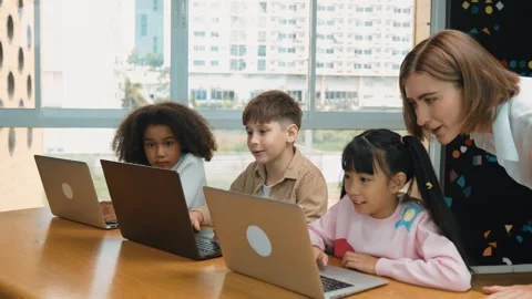 Smart teacher teaching and looking student using laptop at classroom. Erudition. Stock Footage 280795978