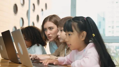 Smart teacher teaching and looking student using laptop at classroom. Erudition. Stock Footage 283686452