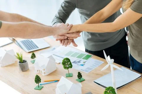 Smart team of engineers shaking hands after finishing a difficult project Stock Photos