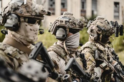 Smart teamwork of soldiers running forward and attacking enemy Stock Photos
