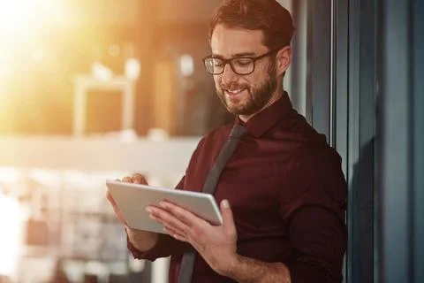 Smart tech for the smart professional. a young businessman using a digital Stock Photos