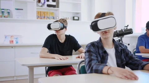 Smart tech students wearing VR headsets using augmented reality for studying Stock Footage 111542103