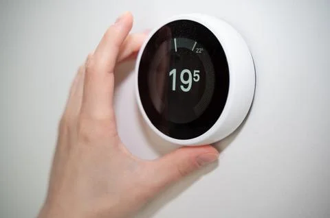 The Smart Thermostat is Adjusting the Temperature Efficiently for Your Over.. Stock Photos