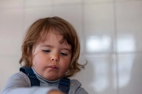 Smart toddler practicing problem-solving with puzzle pieces Stock Photos