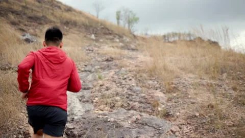 Smart trail runner man running on rocky mountain. Athlete jog, exercising outdoo Stock Footage 171498780