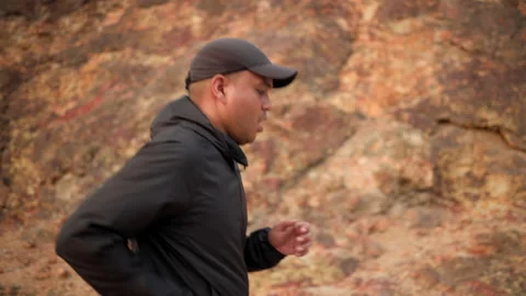Smart trail runner man running on rocky mountain. Athlete jog, exercising. Stock Footage 171793192