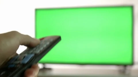 Smart tv and man pressing remote control with rack focus, Green screen Stock Footage 112686483