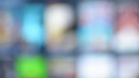 Smart TV interface with blurred colorful icons on screen, creating abstract Stock Footage 320896796