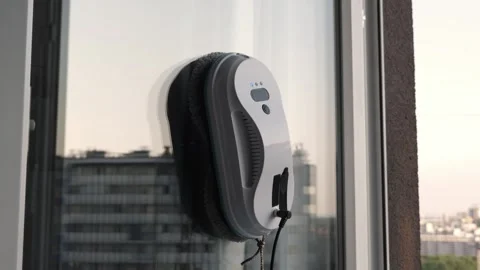 Smart vacuum cleaner washing windows. Home appliance and technology concept Stock Footage 250115027