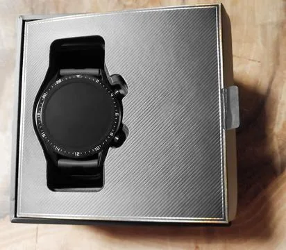 Smart watch in a box. Black smart watch in open packaging. A novelty of smart Stock Photos