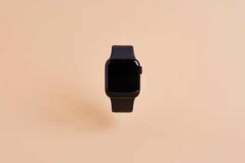Smart watch device isolated on light orange background Stock Photos