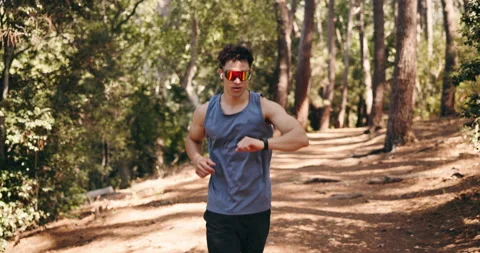 Smart watch, exercise and man in forest, running performance and digital app to Stock Footage 332390618