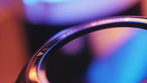 Smart watch in macro rotates and reflects different colors of lighting Stock Footage 187041238