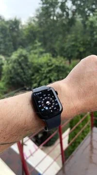 Smart watch on a man's hand, it's raining, shows the weather Stock Photos
