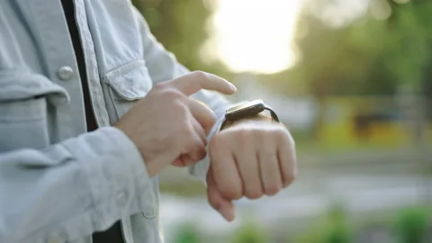 Smart watch. Smart watch on a man's hand outdoor. Man's hand touching a Stock Footage 199239313
