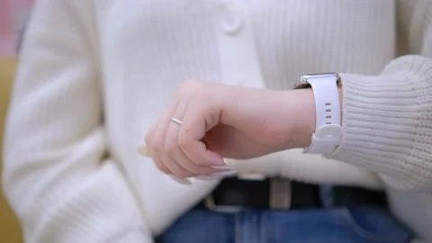 Smart watch. Smart watch on a woman's hand intdoor. Woman's hand touching a Stock Footage 239036717