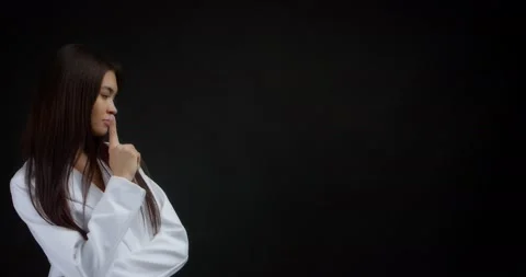 Smart woman is thinking about something, had an idea and she shows a class sign Stock Footage 170197135