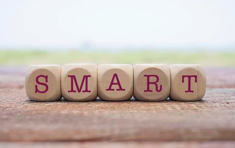 Smart word written on cube shape wooden blocks on wooden table.  Stock Photos