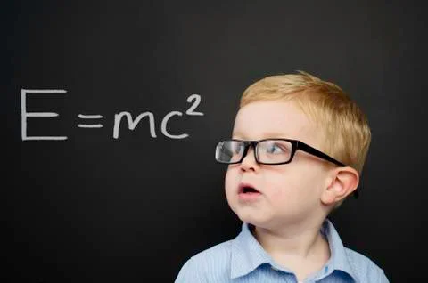 Smart young boy stood in front of a blackboard Stock Photos