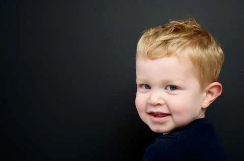 Smart young boy stood infront of a blackboard Stock Photos
