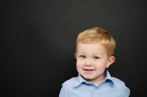 Smart young boy stood infront of a blackboard Stock Photos