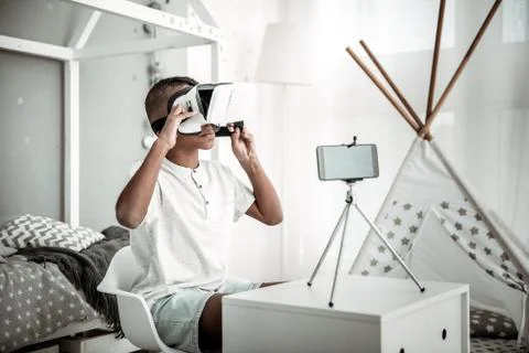 Smart young boy using virtual reality glasses Stock Photos