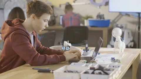 Smart Young Boy Works on a Laptop For His New Robot Programing Project  스톡 동영상 75784355
