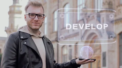 Smart young man with glasses shows a conceptual hologram Develop Stock Footage 99141101