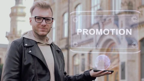 Smart young man with glasses shows a conceptual hologram Promotion Stock-Footage 99400573