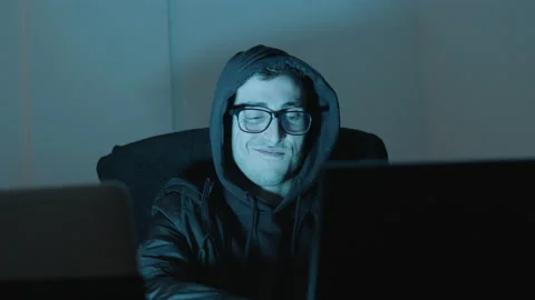 Smart young man in hood working on laptop late at night Stock-Footage 181790603