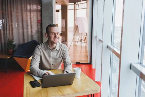 Smart young man looking for information on a website and working as a freelan Foto stock