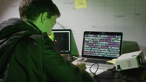 Smart young man working on laptop, making notes Stock Footage 181792400