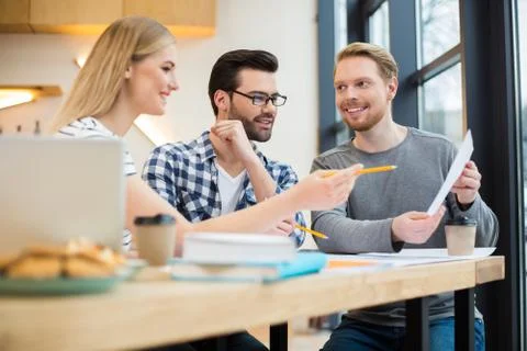 Smart young people looking at the document Stock Photos