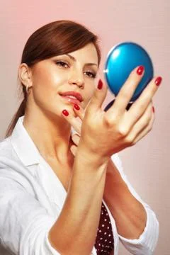 Smartens up with compact mirror Stock Photos