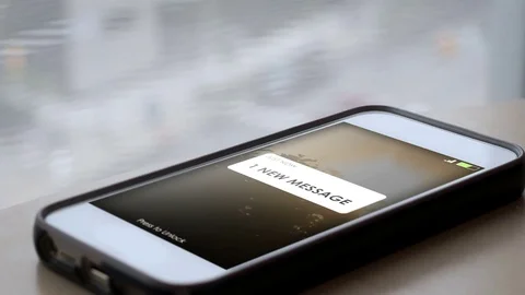 A smartphone with a 1 new message appearing on screen Stock Footage 78886523