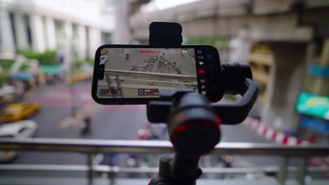 Smartphone On 3-Axis Gimbal Overlooking Busy Street Stock Footage 346282661