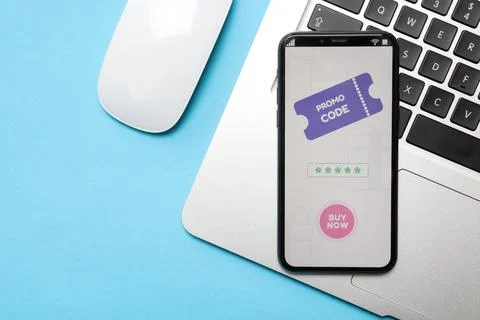 Smartphone with activated promo code, mouse and laptop on light blue backgr.. Stock Photos