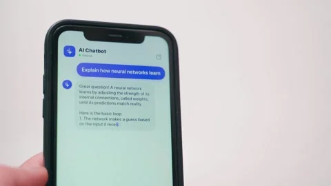 Smartphone with AI chatbot typing a long answer about neural networks. Chat Video stock 342911861